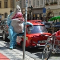 Shark wearing sunglasses whilst leaning on a Trabant