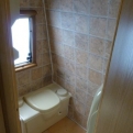 The newly-resealed bathroom with a new temporary floor over the shower tray